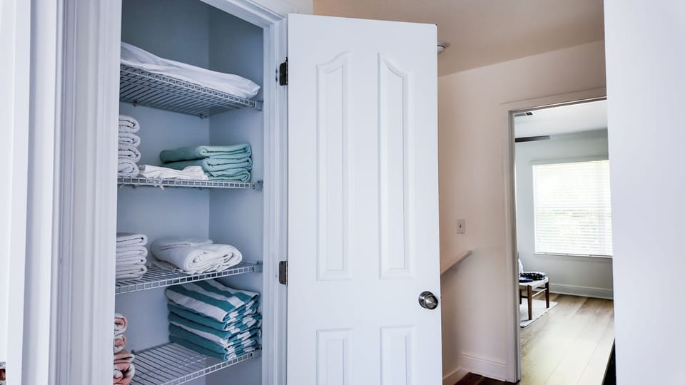 Upstairs linen closet contains extra bedding, towels and pool towels