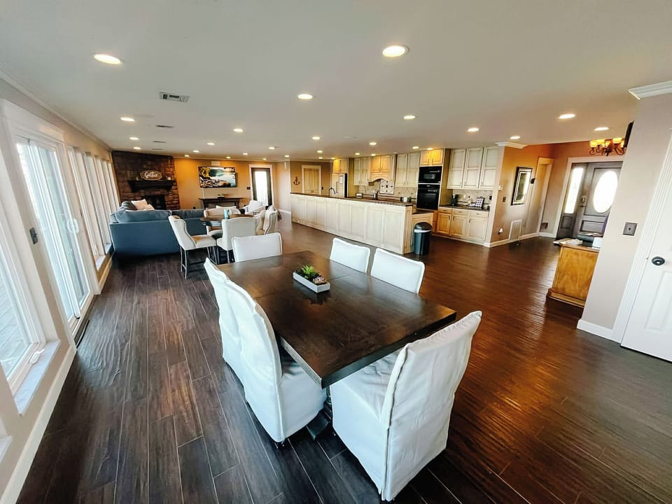 Living room with oversized TV and new furniture with plenty of seating and views galore!