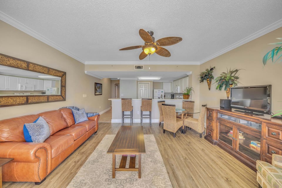 The living room offers ample, comfortable seating with a flat screen television and gulf views.