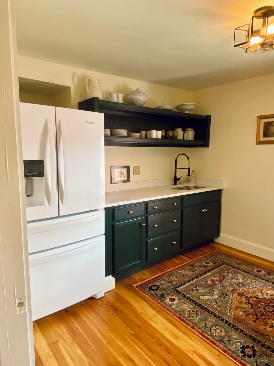Kitchen with full size fridge, oven, microwave, coffee pot, blender, dishes
