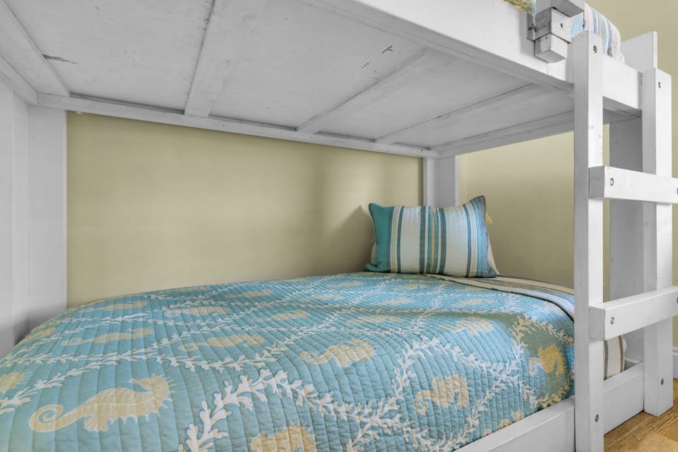 Third Bedroom - A cheerful retreat for little ones or friends, this third bedroom has twin bunks, a TV, and ample space to unwind.