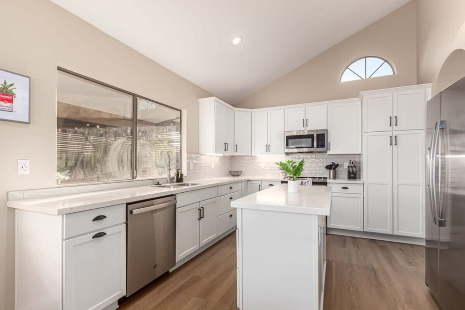 Updated Modern Kitchen with White Shaker Cabinets and Stainless Steel Appliances