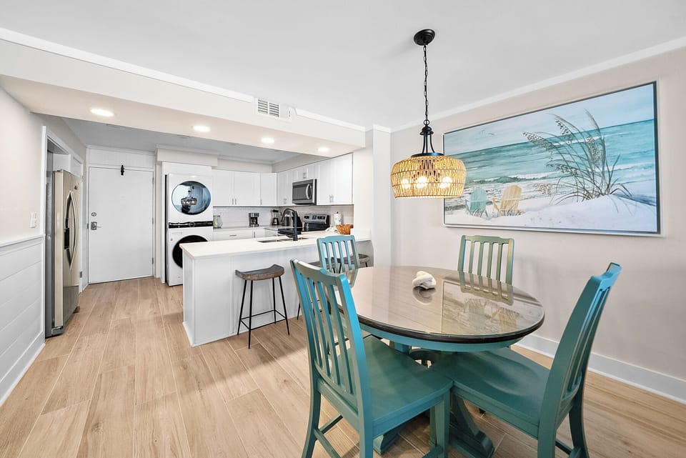 Enjoy coastal comfort in your bright, modern kitchen and dining space with beachy décor and everything needed for memorable meals.