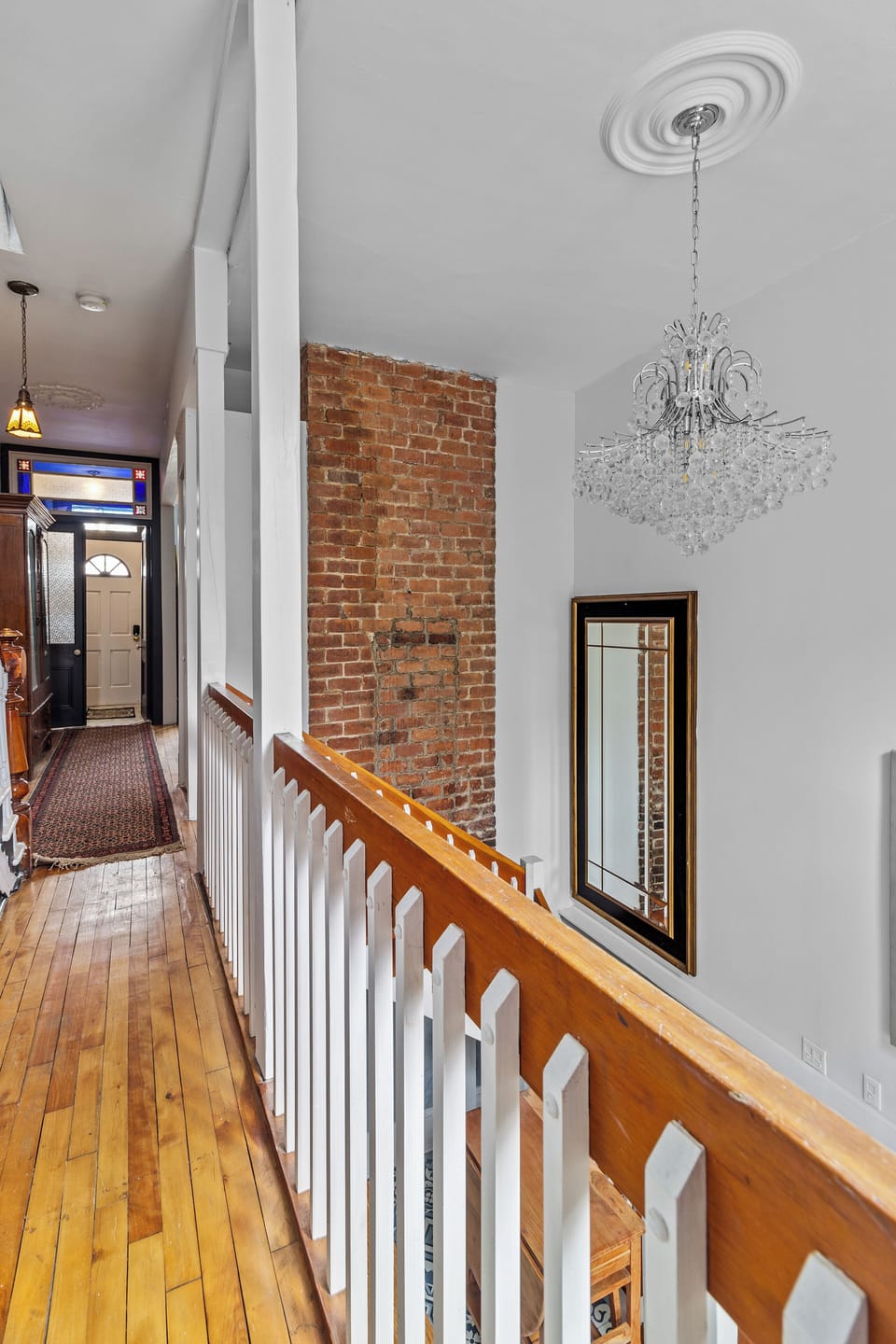 Entryway featuring exposed brick walls