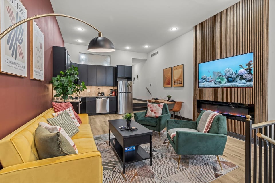 You'll be captivated by this stylish open-concept space where vibrant colors and modern design elements blend seamlessly. Enjoy the cozy seating, charming decor, and the stunning fish tank that adds a unique touch of tranquility.