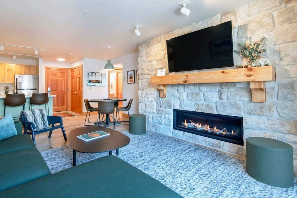 This spacious living and dining area are open to kitchen. Natural tones of green and blue can be found throughout the condo.