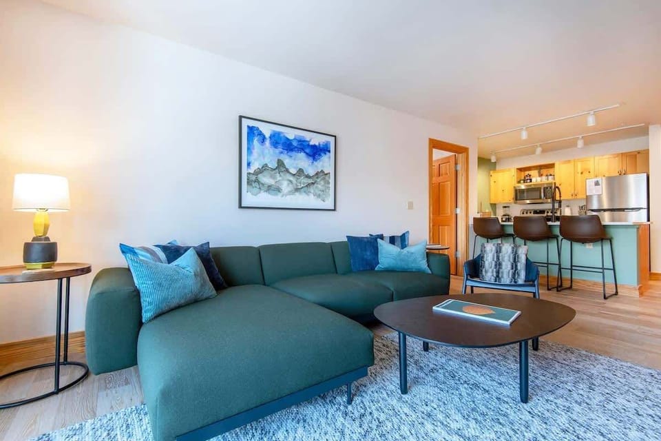 The main living area has enough comfy seating for the whole group to relax around the cozy fireplace or watch TV. 