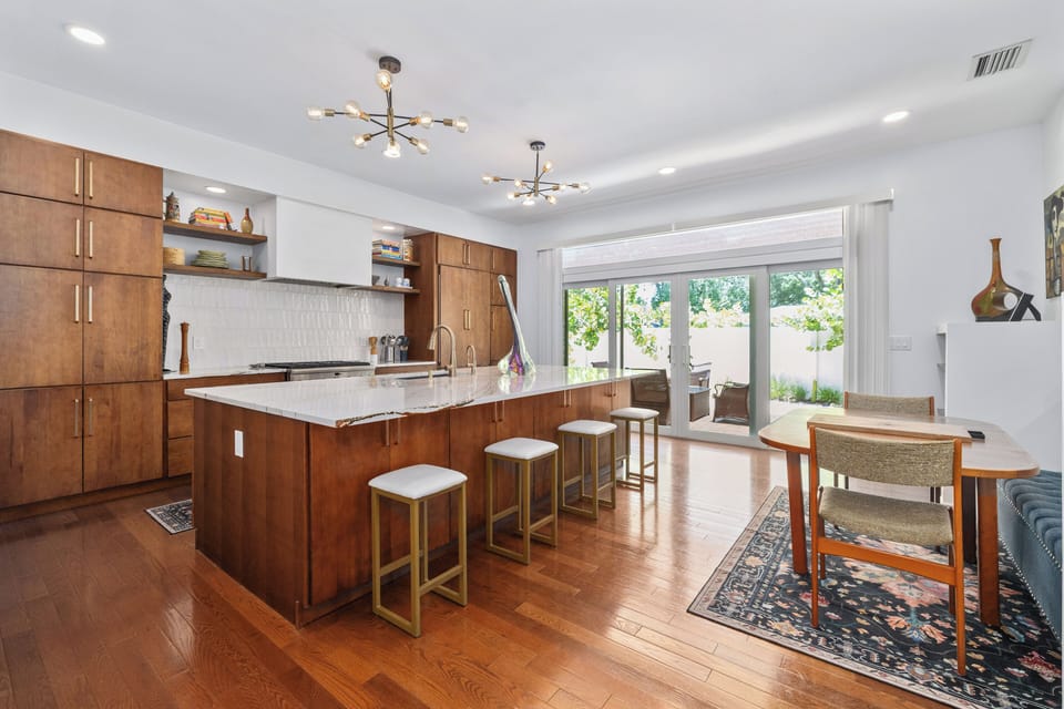 A 6-burner gas stove, electric oven, plus a grill standing ready outside.