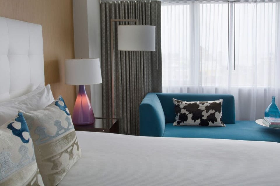 Luxurious bedroom showcasing plush bedding with bold accents, creating a serene and inviting atmosphere.