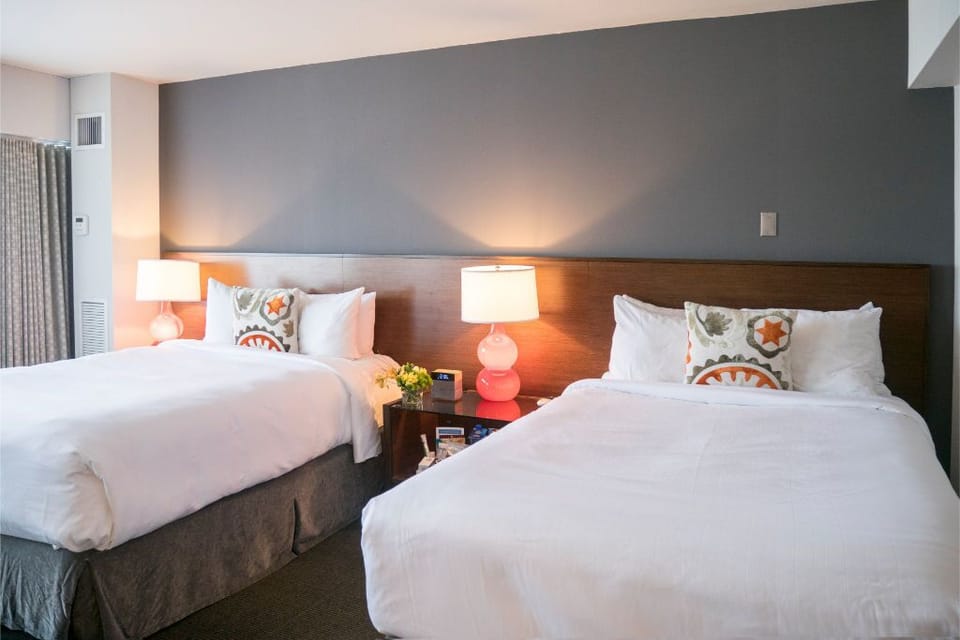 Inviting double bed setup with cozy lighting—great for friends or family to relax together.