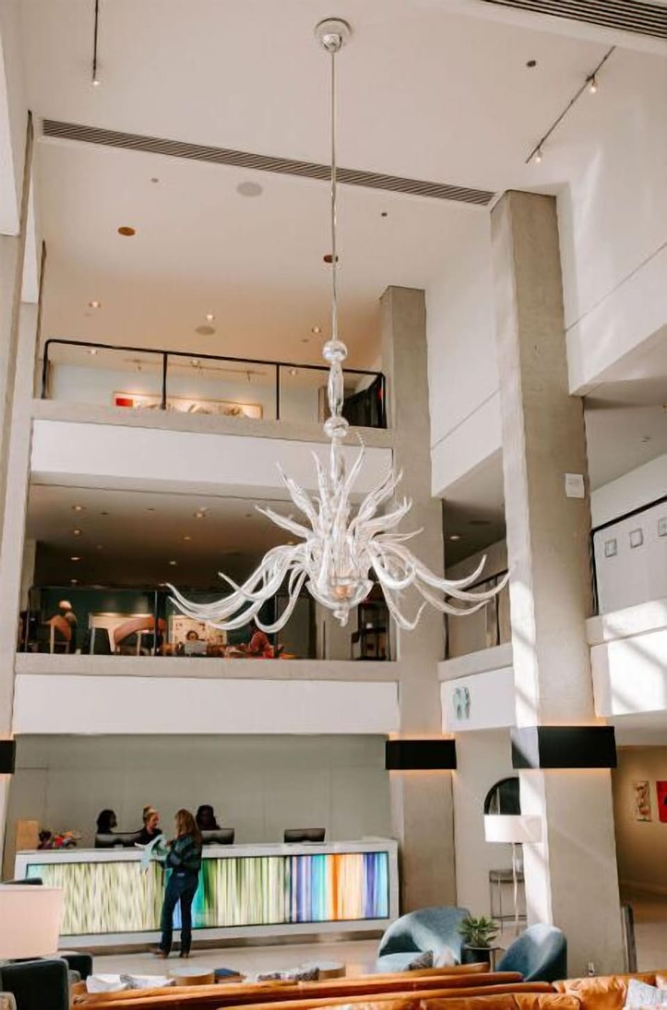 A bright and airy view of the hotel front desk, showcasing the elegant and modern design that welcomes guests.