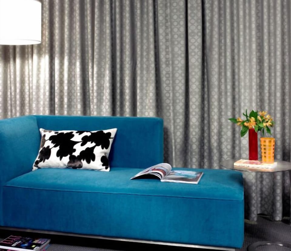 Stylish lounge area with a vibrant sofa and chic decor, perfect for relaxation or catching up on your favorite reads.