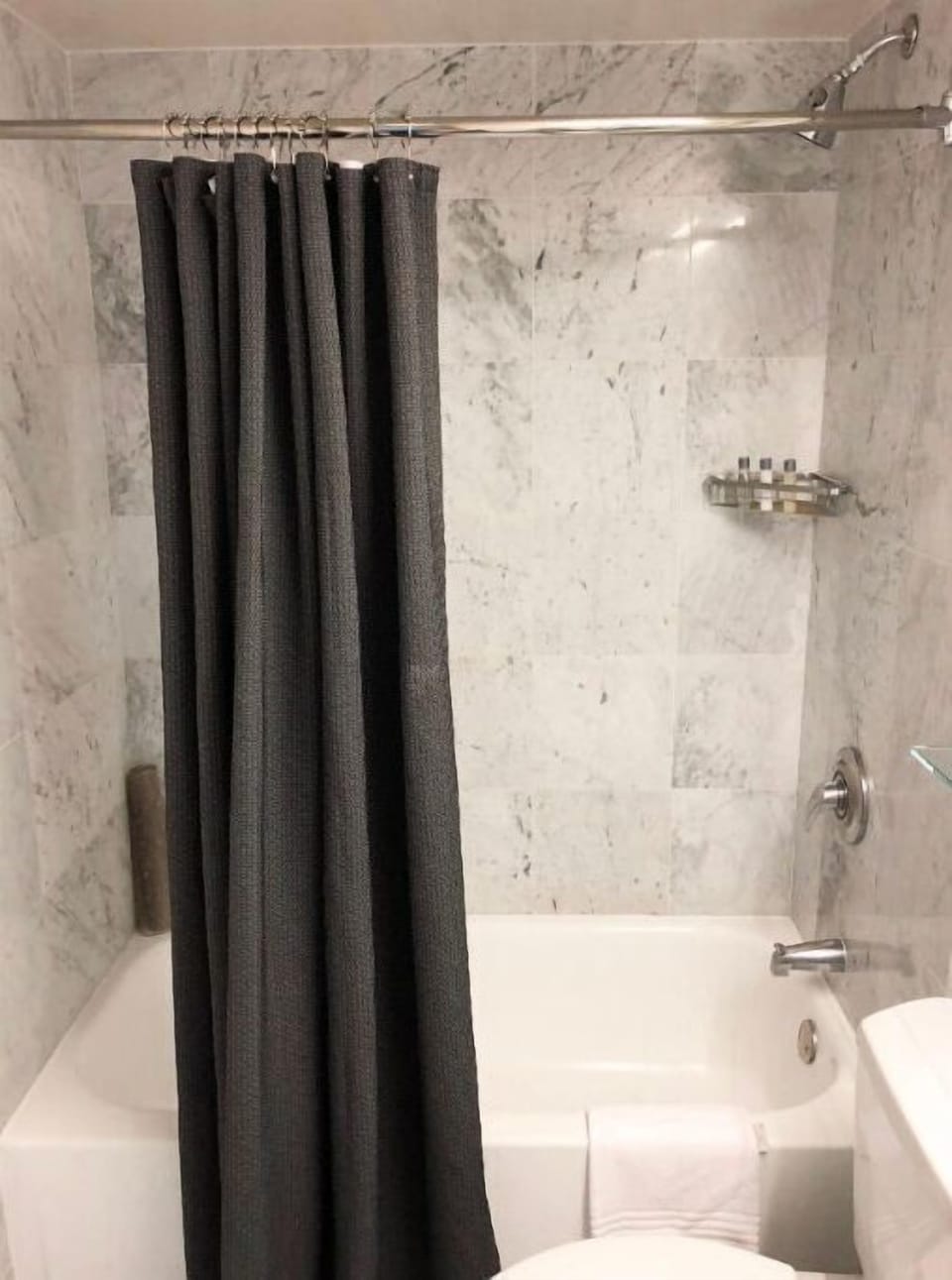 Well-appointed bathroom with a vintage charm, offering a spacious shower and refined decor for a relaxing bath time experience.