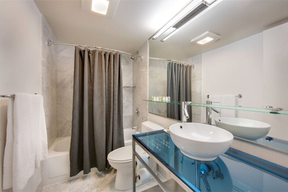 Sophisticated and clean bathroom design, featuring marble details and neutral tones, ensuring a refreshing start or end to your day.