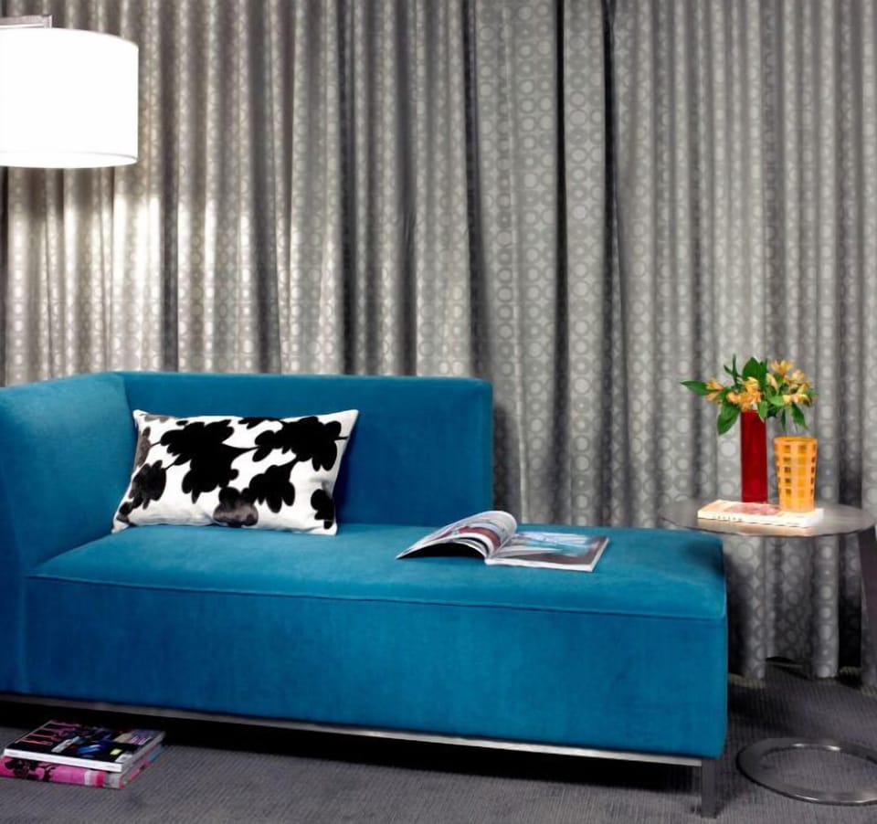Contemporary lounge area with a stylish sofa and modern aesthetic, perfect for relaxation or catching up on reading.