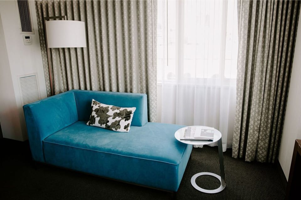 Cozy lounge space with a modern sofa and sleek design, ideal for unwinding or casual meetings.