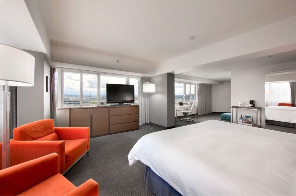 Enjoy the expansive feel of this inviting bedroom, complete with comfortable, bold furniture and ample space to unwind.