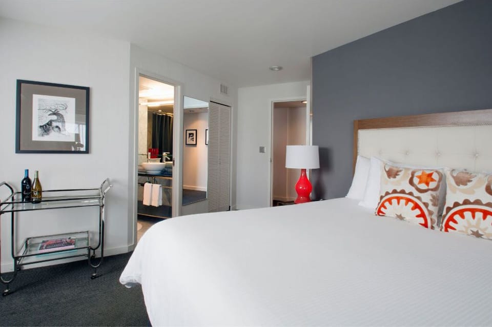 Serene bedroom with stylish accents and ample natural light, ideal for rest and relaxation.