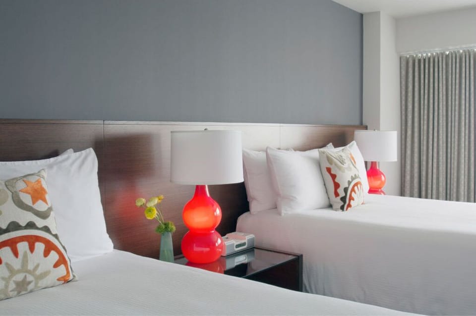 Elegantly designed room with a touch of whimsy, featuring soft textures and bold color accents, creating a restful yet inspiring ambiance.