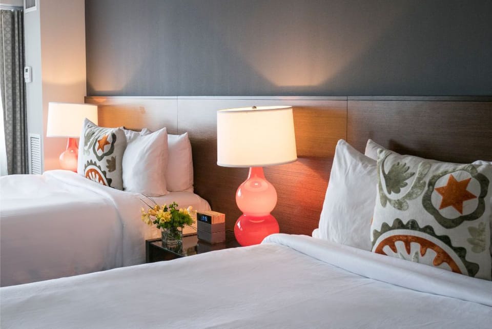 Inviting bedroom with plush bedding and tasteful decor, perfectly arranged for a peaceful night's sleep.