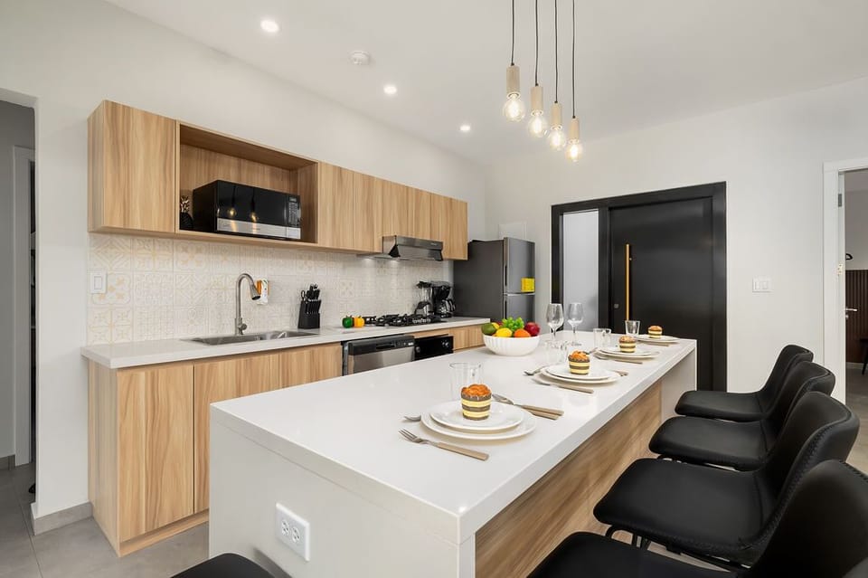 Discover the joy of cooking and dining in our fully equipped kitchen! With sleek countertops, modern appliances, and cozy seating, it's the ideal space to indulge in delicious meals and quality time with loved ones.