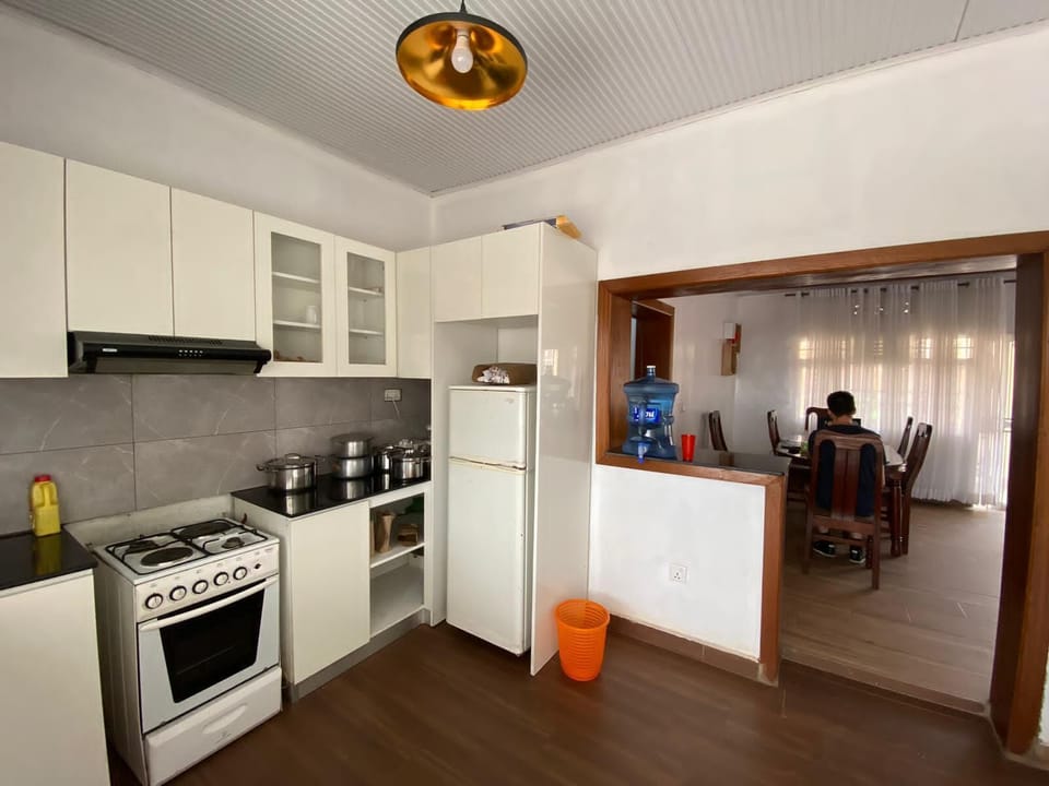 A kitchen with a dining table view, offering complimentary mineral drinking water.