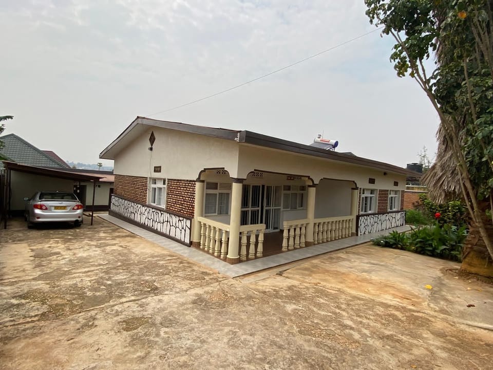 Beyond its four bedrooms, this home offers desirable outdoor features: a charming garden, ample parking for up to three vehicles, and an energy-saving solar water heater.