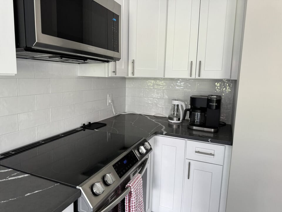 Small space, big convenience! Our modern kitchenette is fully equipped with a microwave, mini-fridge, and all the essential cookware for a quick and easy meal.