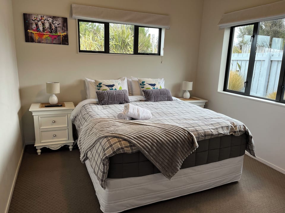 King size bed with a wall mounted smart TV