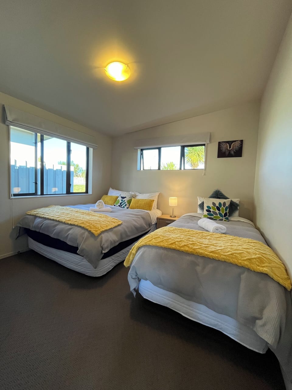 Queen and king single beds with a wall mounted smart TV