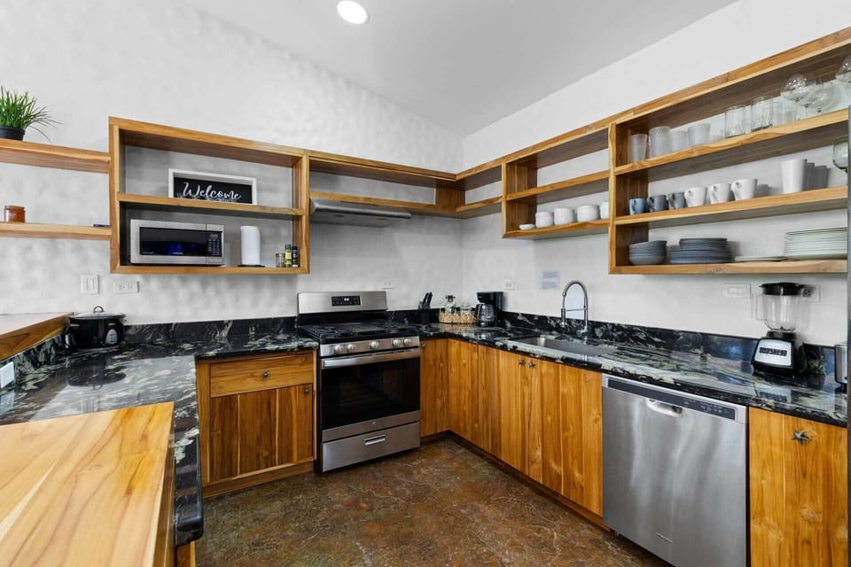 Welcome to the main kitchen is a chef’s and entertainer’s dream space all made from fine teak wood and covered in granite and marble details