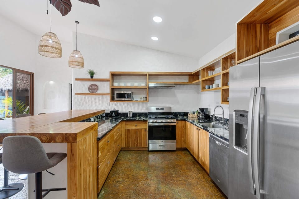 kitchen area overlooking the beautiful pool and outdoor waterfall