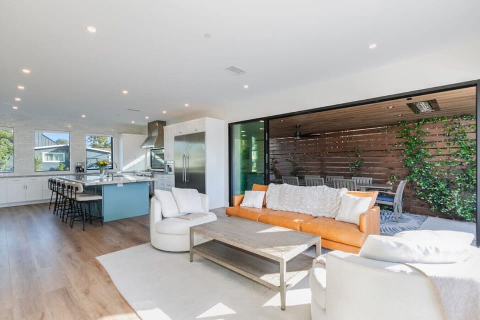Step into a haven of relaxation in the living area, featuring a huge sofa and a round couch, with a large flat-screen TV above the indoor fireplace.