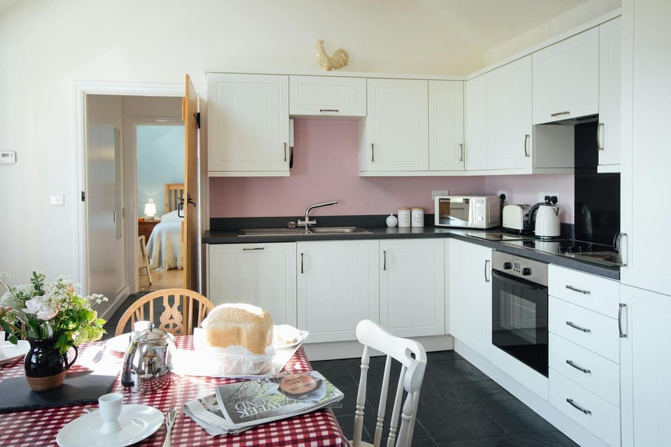 Fitted kitchen/dining area: built-in oven and hob, microwave, kettle and toaster; dining table and chairs