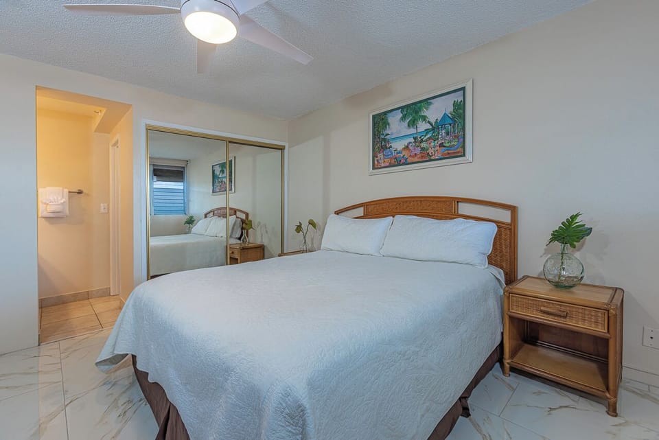 Relax in your coastal retreat, where a plush bed and island-inspired decor invite restful nights after exploring all day.
