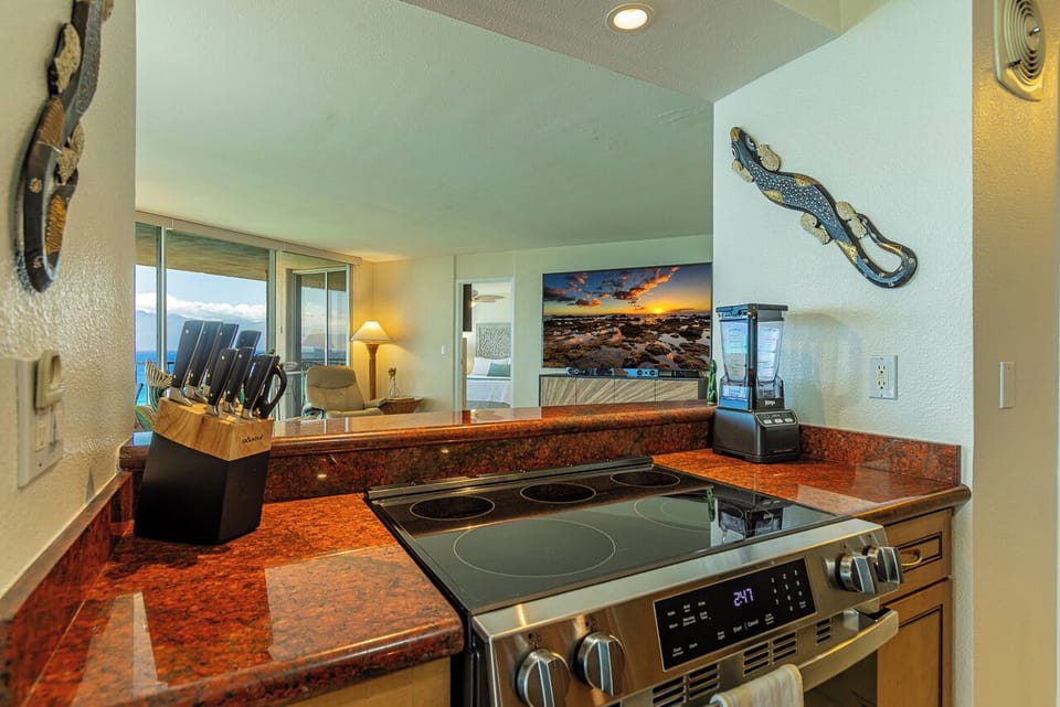 Your kitchen opens to a stunning ocean view, with rich granite counters, a modern stove, and everything you need to prepare meals while watching the waves through the living room's large windows.