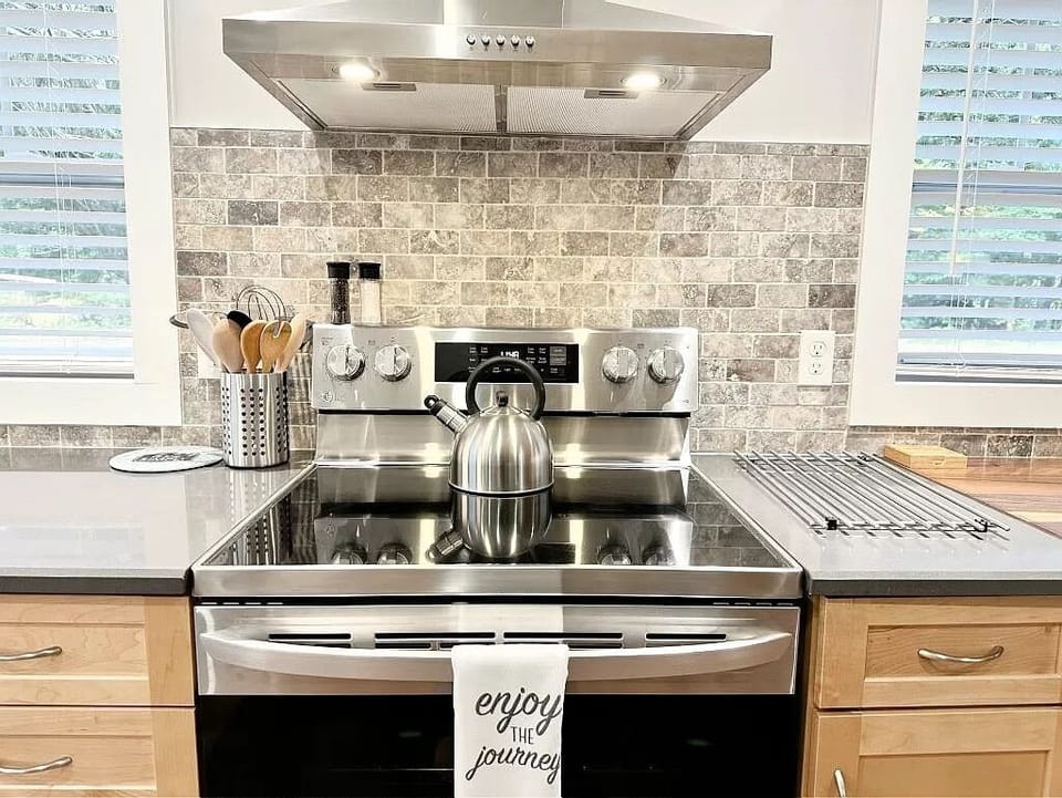 Electric stove and oven with hood vent.