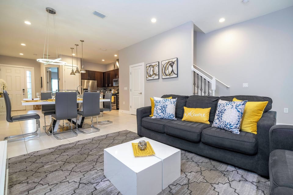 A spacious living room with comfortable seating and a large TV, perfect for family gatherings and entertaining