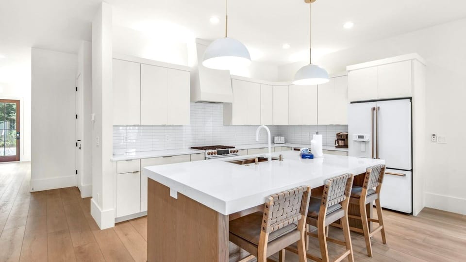 Chef's kitchen with GE Cafe appliances and double oven.