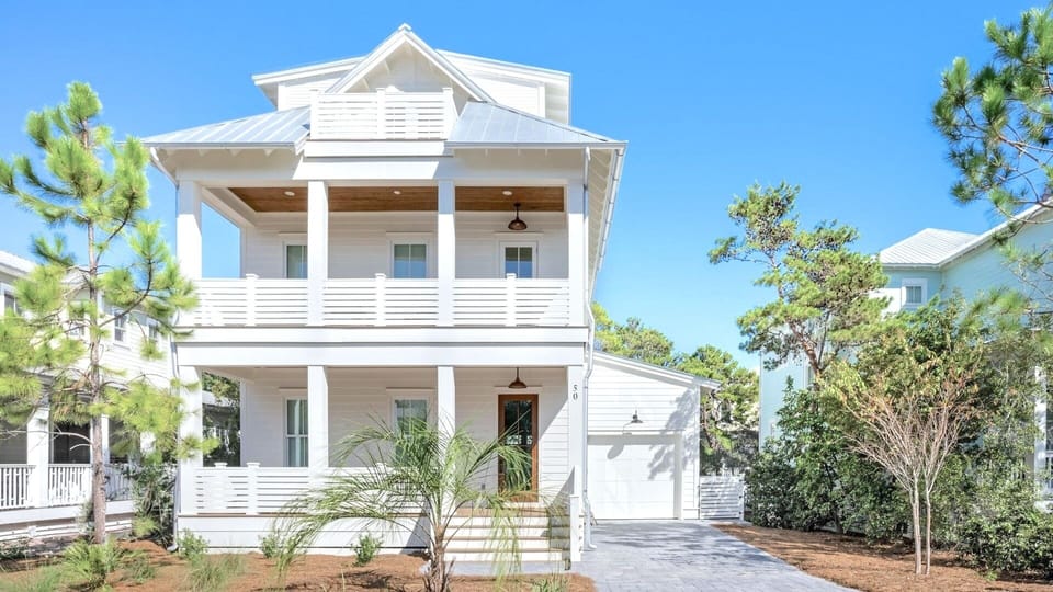 Beautiful 2.5 story house with garage and driveway parking.