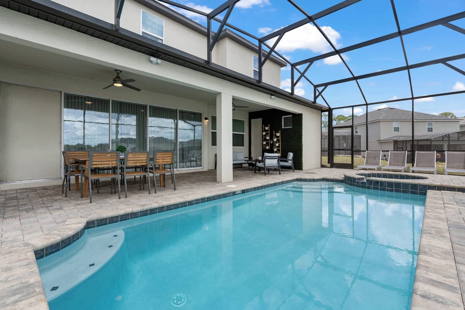 Welcome to your private oasis with a sparkling pool, chic patio furniture, and plenty of dining space. The screened enclosure offers the perfect blend of indoor comfort and outdoor relaxation for your sun-soaking moments.