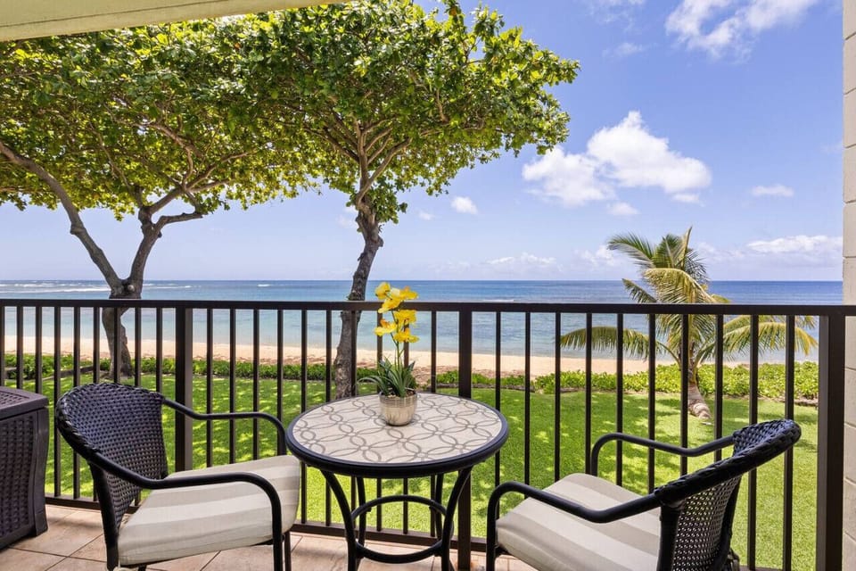 Balcony bistro set overlooking greenery for relaxed coffee moments.