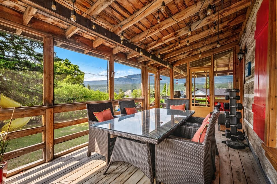 Covered front porch with an enclosed dining area.