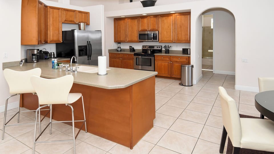 The kitchen is equipped with stainless steel electrical appliances