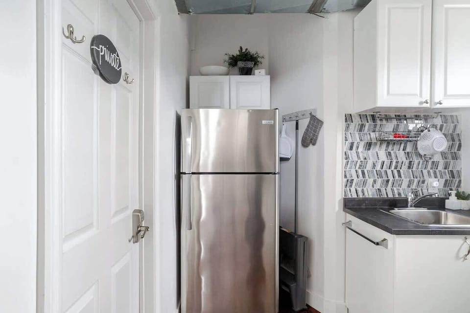 A welcoming kitchen setup with stainless steel accents, crisp white cabinets, and everything you need to feel at home.