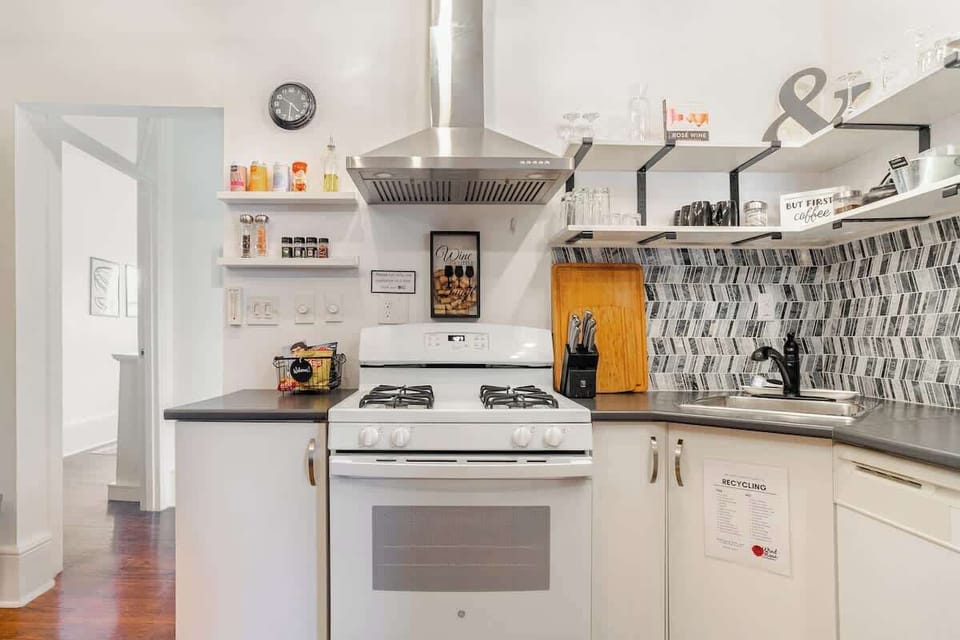 Stylish and practical—featuring a full-size gas stove, cooking tools, spices, and sleek open shelves.