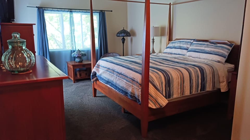 Master bedroom with king bed and TV..  Sliding door to upper deck.