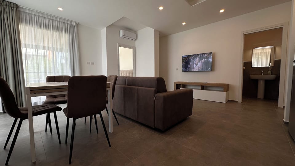 Deluxe Apartment, Garden View | Living area | 43-inch Smart TV with cable channels