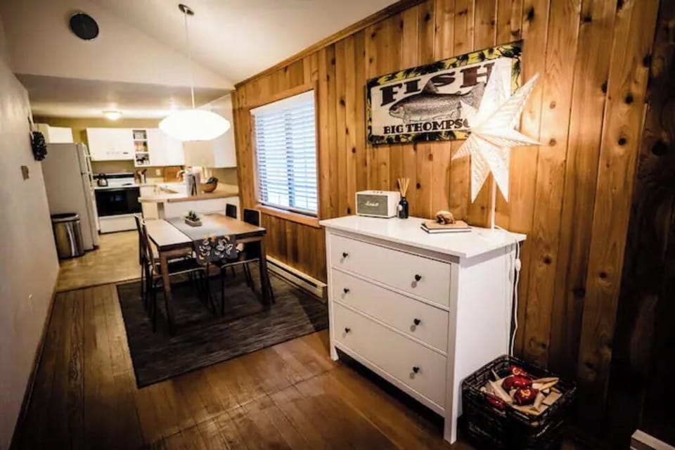 Dresser near sofa bed w/ linens and games.