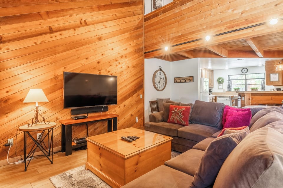 Living room, wood burning fireplace, flatscreen TV, shuffleboard